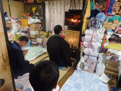 住職が仏壇の供養を行っている画像