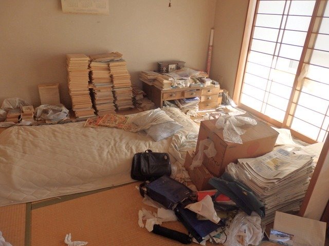 大量の本や新聞が並ぶ部屋